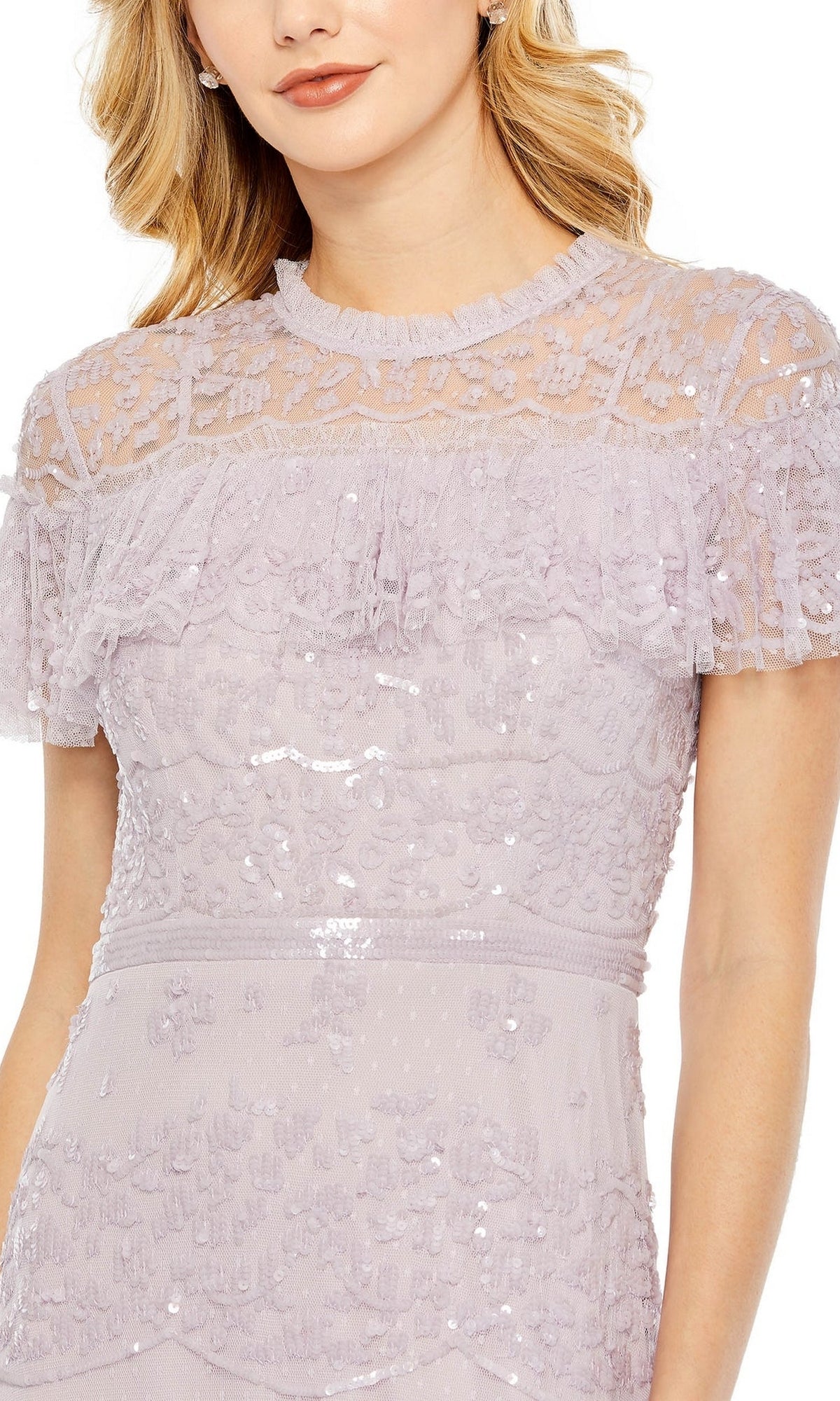 A woman wears the Mac Duggal 9195 Lilac Long Sequin Formal Dress featuring short sleeves, lace accents, and sheer detailing on the upper chest and sleeves.